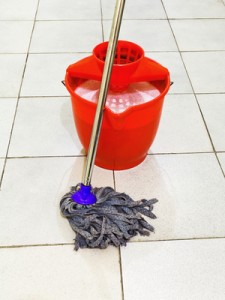 red bucket with foamy water and mop the floor